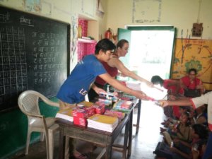 Handing out dental products and school supplies in India