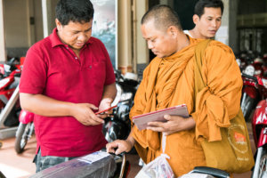 Buddhist monk picks out the perfect motorbike in Cambodia