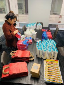Suzie's team assembling hygiene bags for women experiencing homelessness