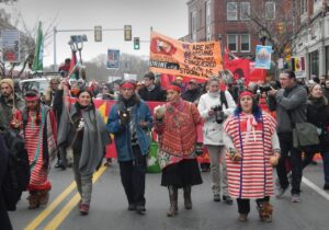 Members of the Wampanoag marching in native dress