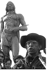 Wampanoag leader Frank James speaks in front of statue of Massasoit. Image: http://www.uaine.org/