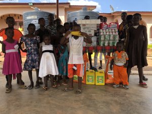 Children standing with donations