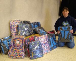 Susan Mickelson displays backpack donation