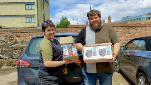 Tobias drops off donations of music equipment with Charlie