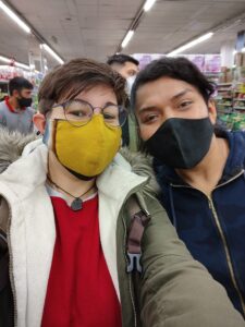 Macarena and Anahí smiling beneath their face masks for a photo while shopping for food for Anahí