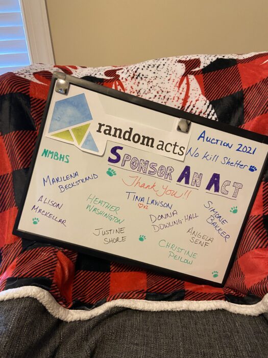 Whiteboard with Random Acts logo and a title saying Sponser An Act. Donor names are listed on board with a Thank You!