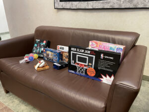 Games and toys spread out on a brown couch